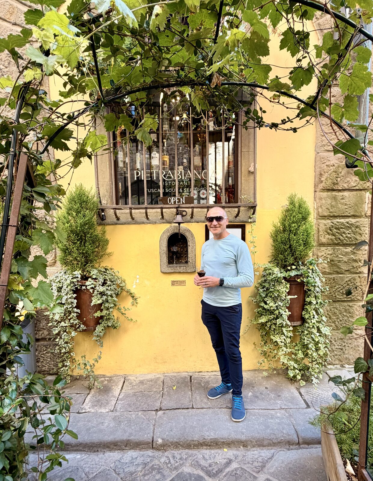 Lance enjoying a glass of wine at one of Florence's secret wine windows